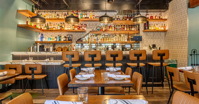 Interior, tables and chairs near bar