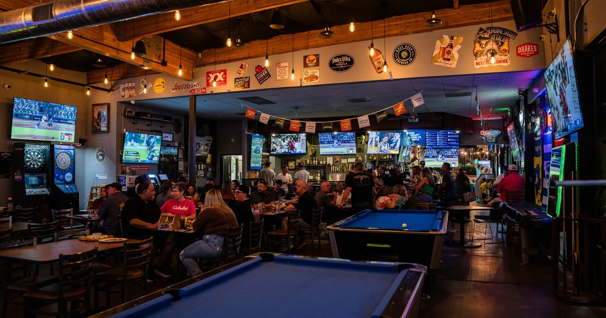 Interior, seating space with pool tables and arcade games