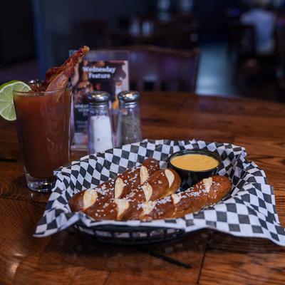 Three jumbo pretzels served with cheese sauce and Bloody Mary.