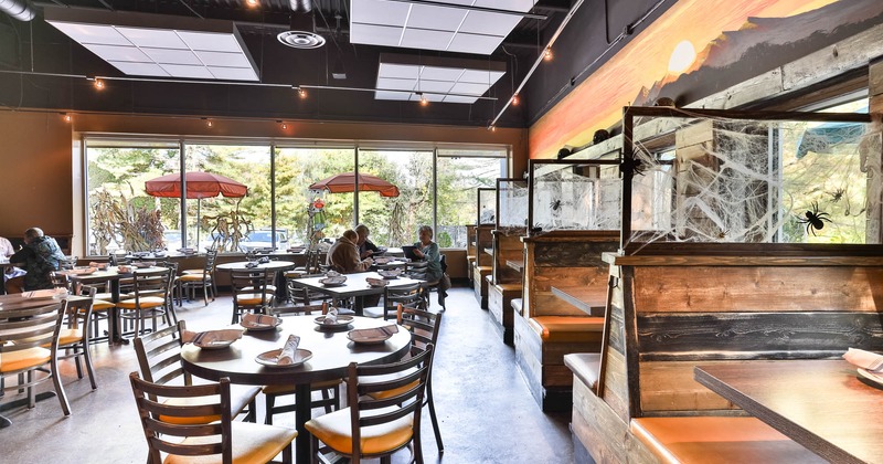 Interior, set tables and chairs, seating booths on the right