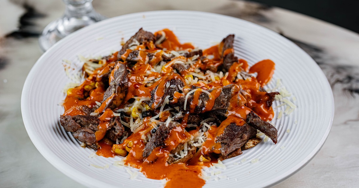 Power Bowl, loaded steak  savory dish with melted cheese and a red sauce