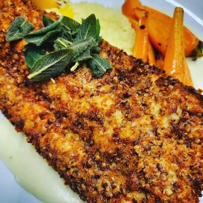 Crusted and fried fish fillet, on a bed of mashed potatoes