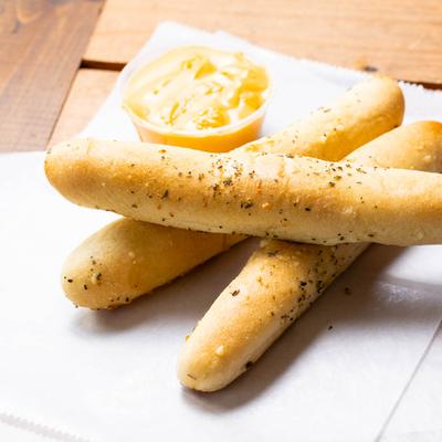 Breadsticks with cheese dip.