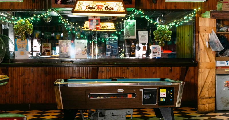 Interior, pool table with bar in the back