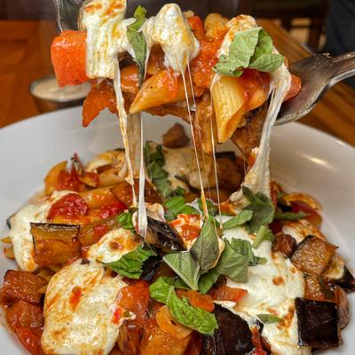 Penne Casalinga pasta with eggplant, fresh tomato, and mozzarella in a light marinara sauce.