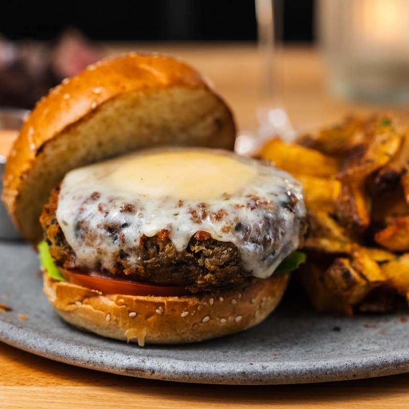 menu item 19 of 22, Mushroom Chickpea Burger, NY State Cheddar, Ginger - Sesame Aioli, Lettuce, Tomato, Hand - Cut Fries