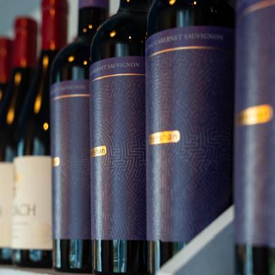 Bottles of wine lined up on a shelf