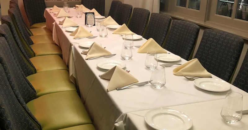 Spacious and cozy interior dining area with dining tables set for guests