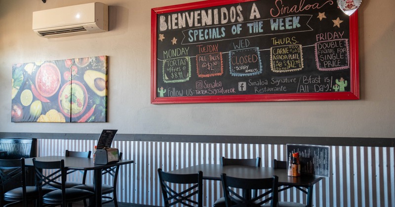 Interior, dining area, tables with chairs, ready for guests, menu board on the wall