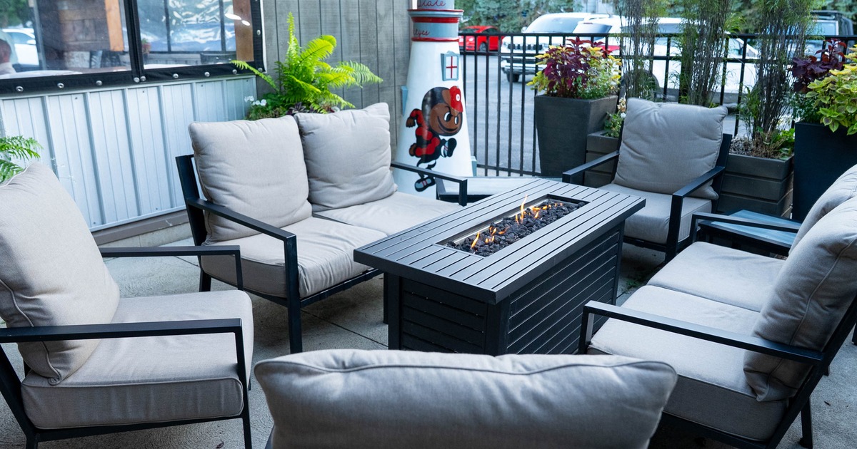 Outdoor seating area, seating set around the fire pit, potted plants as a decoration