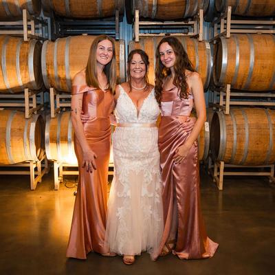 Wedding photo of a bride and daughters in the Barrel Room.