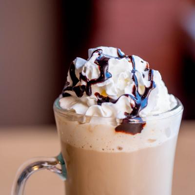 Irish Coffee topped with whipped cream and drizzled with chocolate.