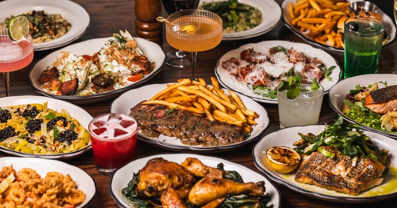 Various dishes and cocktails on a table