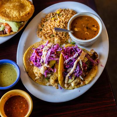 Fried Fish Tacos served with rice, beans amd dipping sauces.