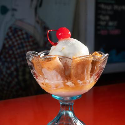 Coconut Ice Cream With Fried Bananas, Honey And Sesame Seeds.