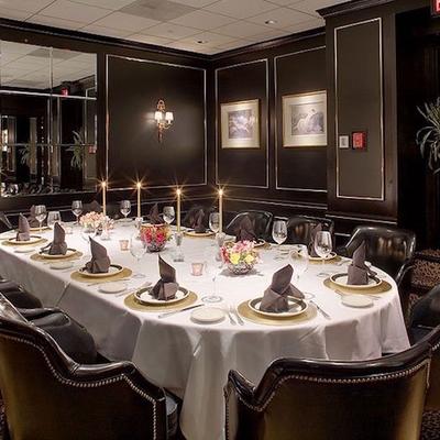 A set dining table for twelve with floral decoration and candle lights