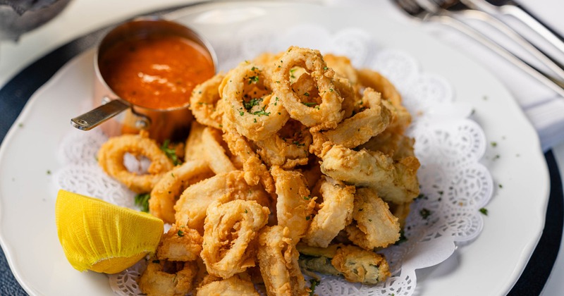 Fried calamari and zucchini served with a dipping sauce