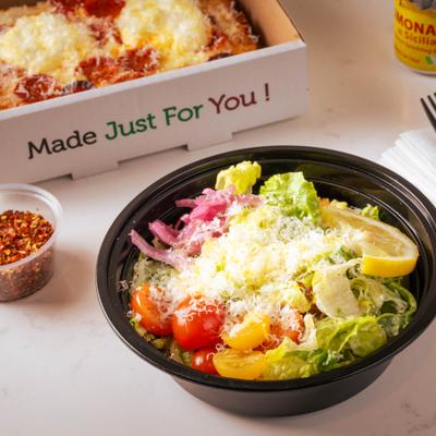 Caesar salad and ricotta hot honey pizza slice.
