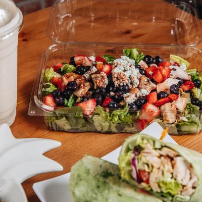 Mixed berries salad and Southwest wrap, served.