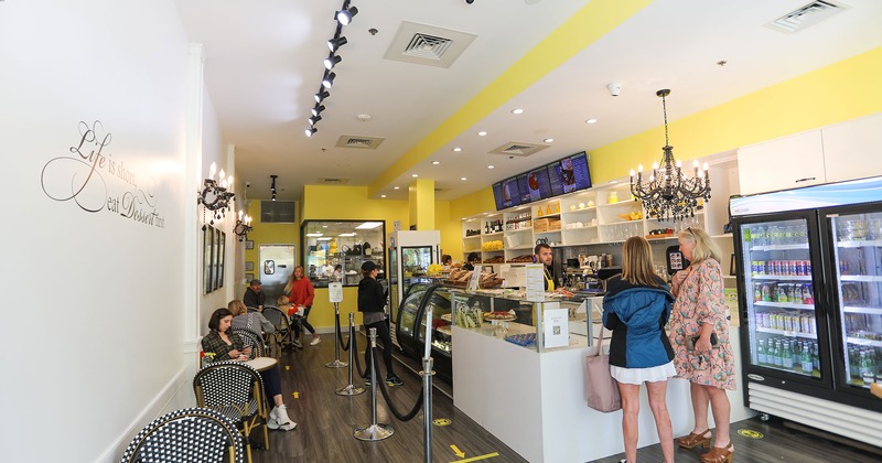 Interior, tables and seats by a wall, order counter