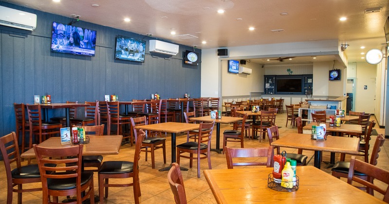 Spacious and cozy dining area with dining tables ready for guests