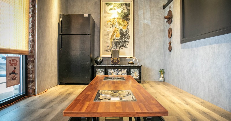 Interior, long low seating Korean barbecue table with two stoves