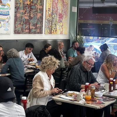 Guests dining at tables.