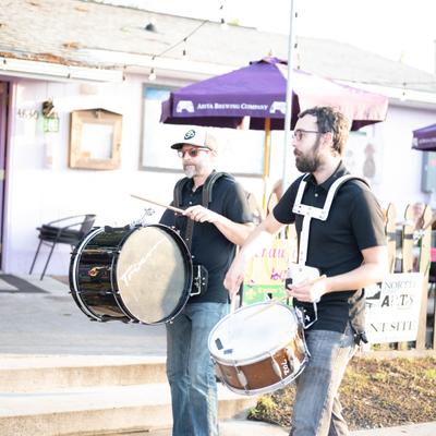 Outside, percussionists performing.