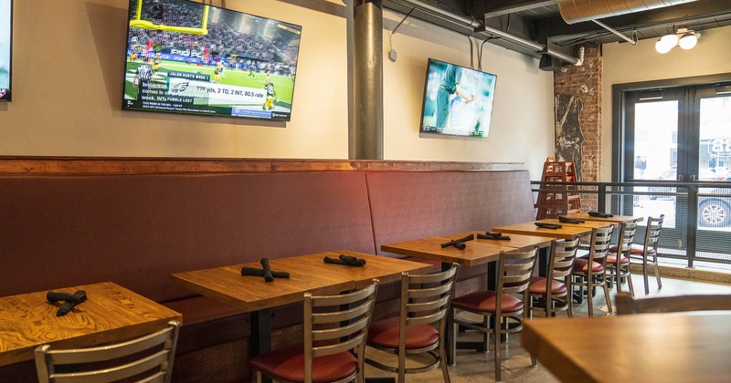 Interior, bench seating, big TVs on the wall