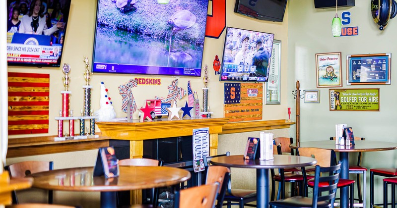 Interior, seating area, large TVs on the wall