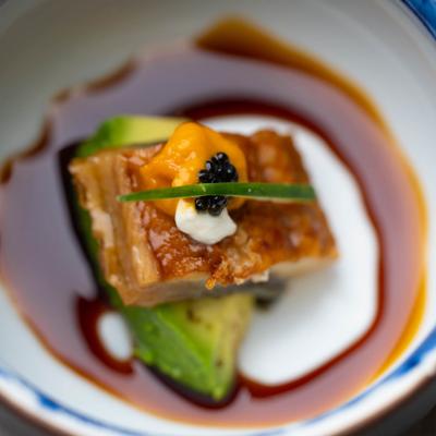 Unagi served atop avocado and topped with sea urchin, cream cheese, and caviar.