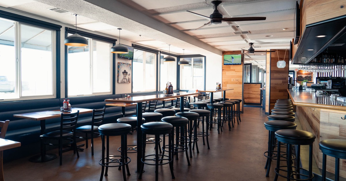 Interior, long leather bench, long high tables and bar stools