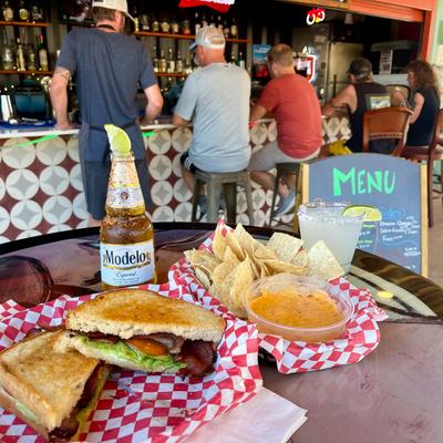 BLT sandwich, chips, and dip.