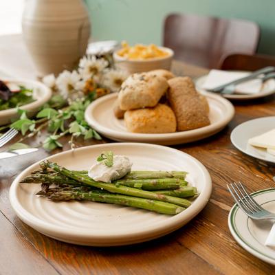 Grilled asparagus with ricotta, and pastries in the background