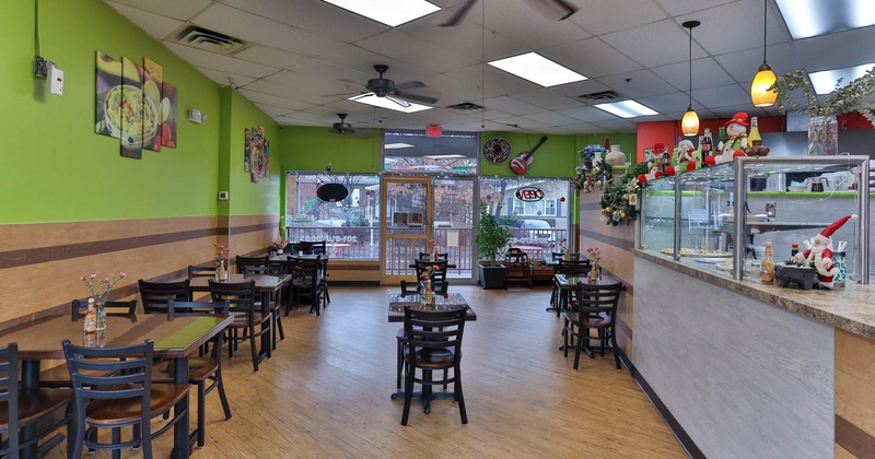 Interior, dining area, wooden top tables for four and two, entrance, shop windows