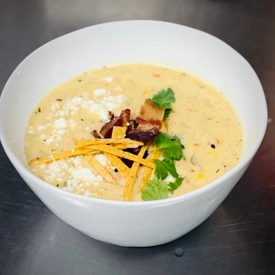 Southwest Corn Chowder Soup with Bacon, Queso Fresco and Corn Tortilla Strips.