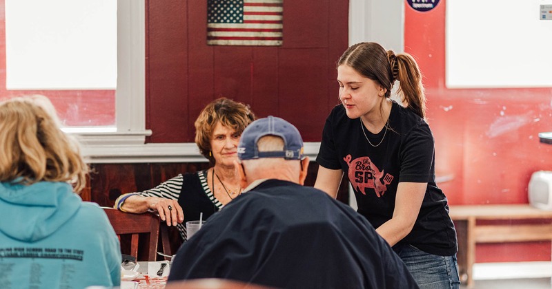 Staff member serving a table