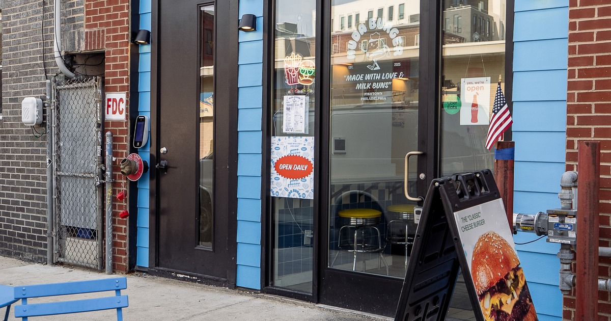 Exterior, entrance, side walk patio, tables, xhairs, sign  above