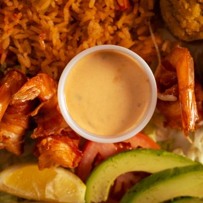 Camarones Imperiales with a dipping sauce, close-up.