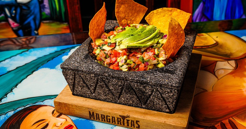 Guacamole and salsa in a stone bowl