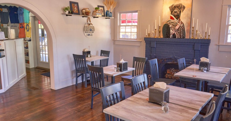 Interior, tables and chairs next to the decorative fireplace