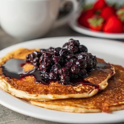 Pancakes toped with blueberry jam, closeup.