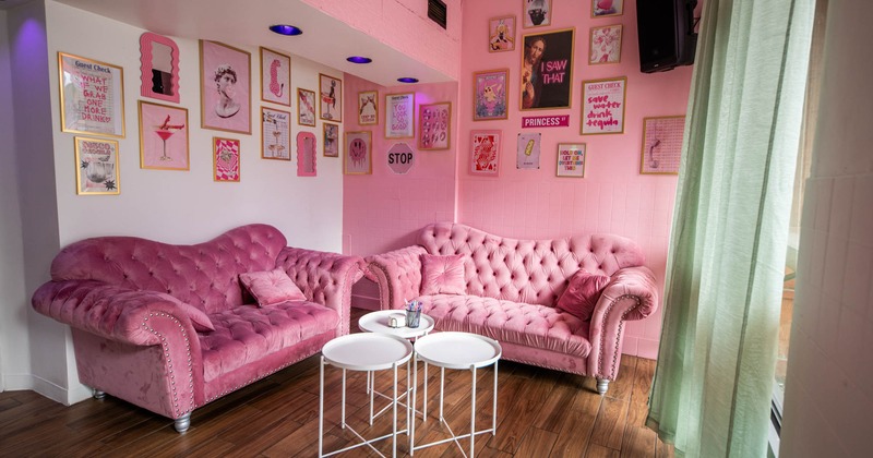 Lounge area in pink decoration, with pictures on the wall