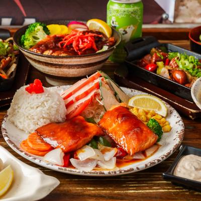 Salmon teriyaki with rice, grilled glazed fish, and side dishes.