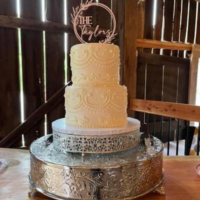 Rustic interior with a wedding cake on an embellished sliver stand
