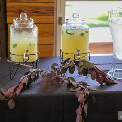 Two bottles of limunade and a bottle of water