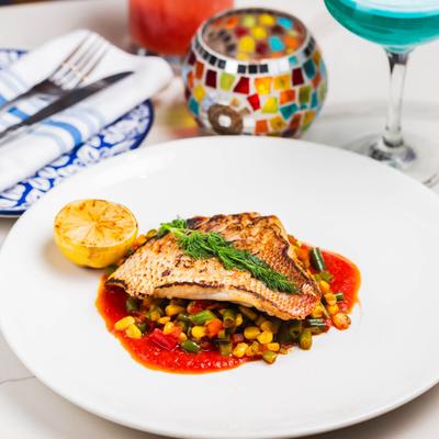 Sauteed Red Snapper atop veggies.