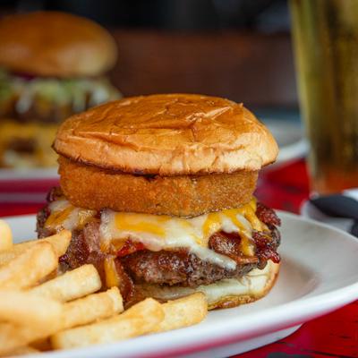 BBQ Burger topped with melted cheese, bacon and a onion ring, served with fries.