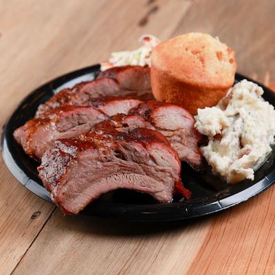 Grilled meat, salad and pastry closeup