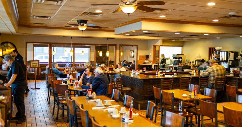 Diner area, food line behind the tables and chairs